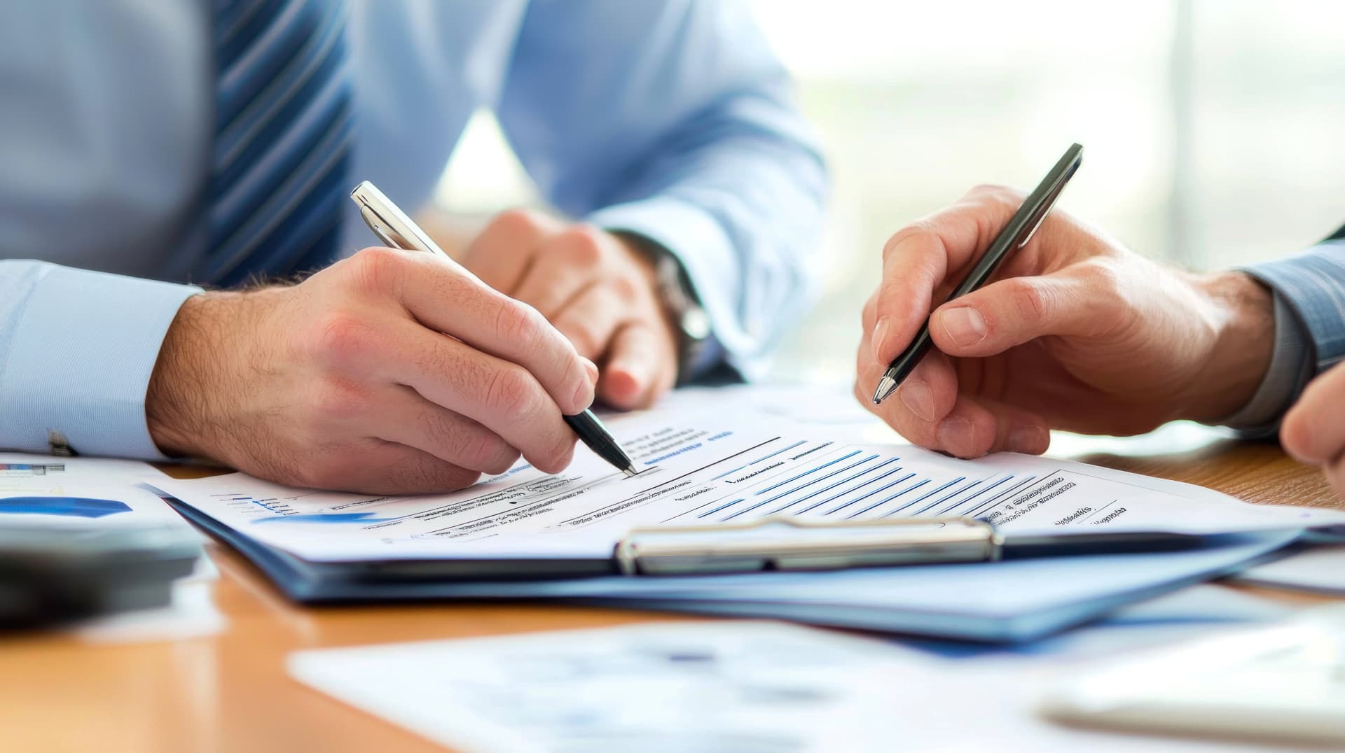 Signing a contract on a bright table